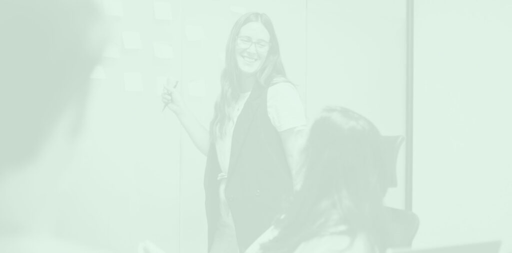 Growketer presenting in front of a team